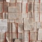 Books layered on a table. 