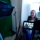 Image of woman sitting in front of camera. 