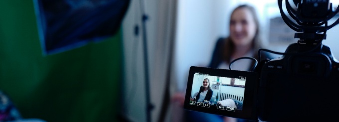 Image of woman sitting in front of camera. 