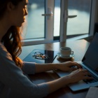 Woman typing on a computer. 