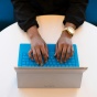 Woman typing on a laptop. 