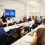 Students sitting in a large lecture hall. 