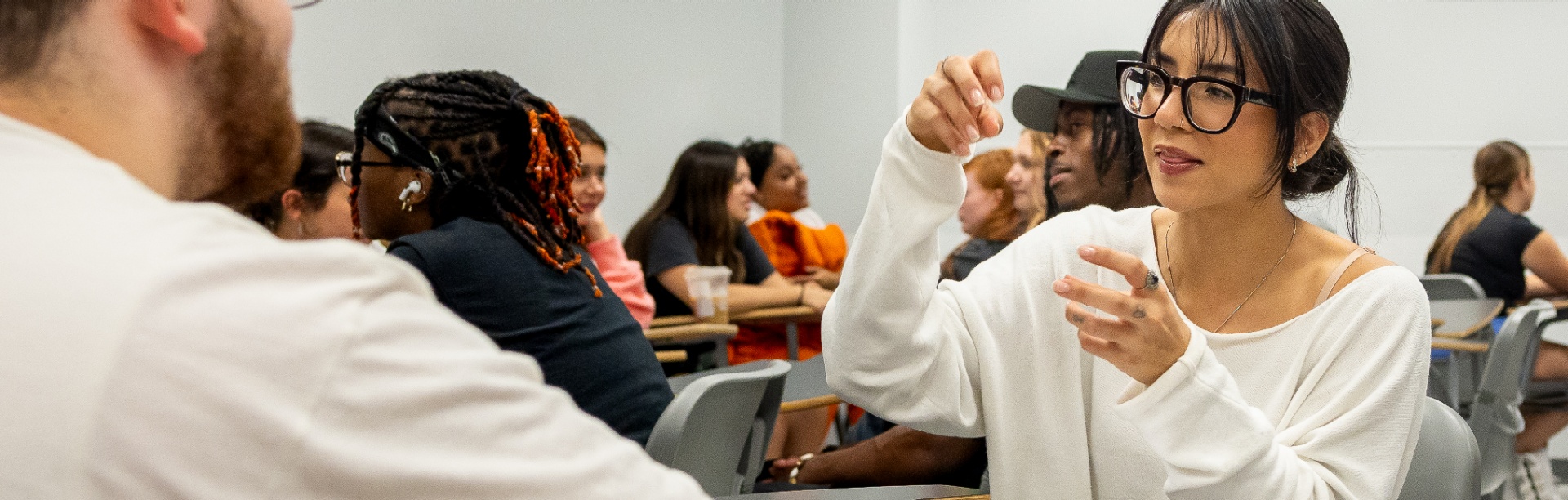 Students talking in a classroom. 