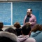 Corey Placito shares a lecture in a classroom full of students. 