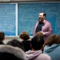Corey Placito shares a lecture in a classroom full of students. 