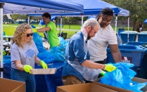 Volunteers sort through trash collected at UB for a trash survey. 