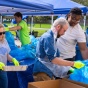 Volunteers sort through trash collected at UB for a trash survey. 