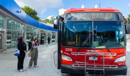 People next to Metro bus.