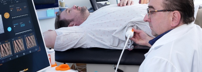 Doctor examining a patient using ultrasound technology.