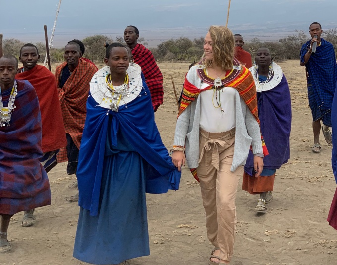 A picture of a student walking with members of the Maasai Tribe in Tanzania.