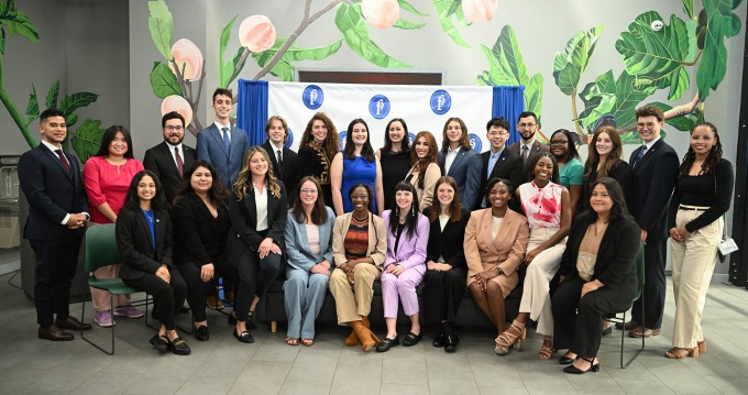 College students sitting in business attire while posing for a professional group photo. 