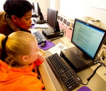 two people looking at a computer. 