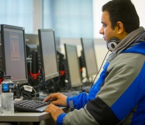 person sitting looking at a computer screen. 