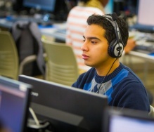 person with headphones on working on a computer. 