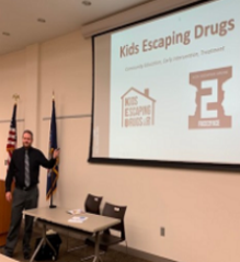 A TV screen with a movie on it, and popcorn and jack-o-lanterns in the foreground.