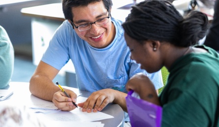 Two students reviewing a paper. 