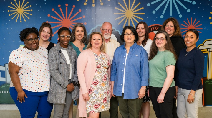 Exploratory and Pre-Professional Advising Center staff standing for picture and looking at camera in Capen Hall. 