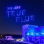 A light show over Baird Point displays the saying, "We are True Blue.". 