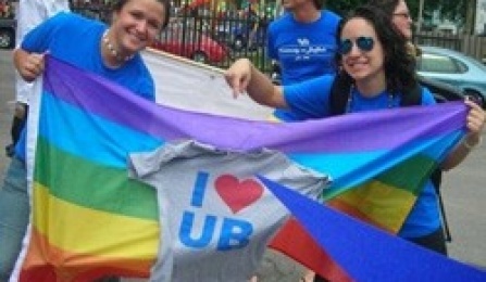 Students with a rainbow flag and "I Love UB" shirt. 