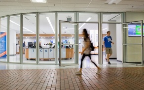 students walking past the open doors of 1 Capen.