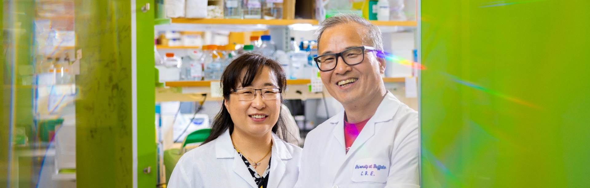 Portrait of Soo-Kyung Lee (right) and Jae W. Lee (left), researchers with Biological Sciences in the College of Arts and Sciences, photographed in June 2024 in a research lab in Cooke Hall. Photographer: Douglas Levere. 