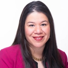 Image of Monica Ramirez, a Latina woman with straight dark hair wearing a pink jacket. 