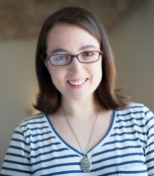 Image a brown-haired woman in a blue and white striped shirt. 