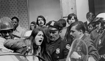 Police with a stick arresting a protesting student in the ant-war protest at UB in 1970. 