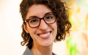 Woman with short dark hair, smiling at the camera.