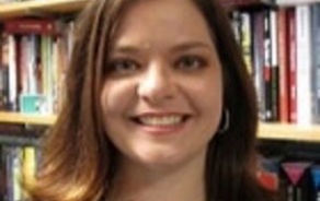 Woman with dark hair smiling at the camera.