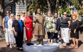 Group of women with statue.