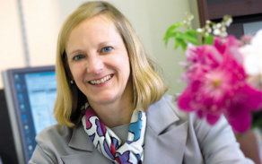 Woman with blonde hair, smiling at the camera.