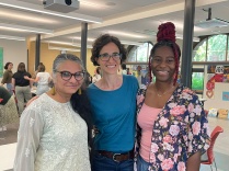 Three peope smiling at the camera.