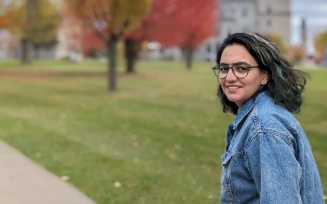 Person outdoors in a dark shirt, smiling at the camera.