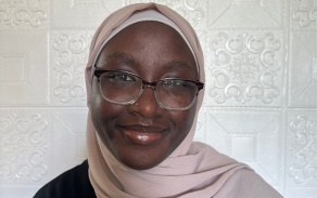 Person in glasses, smiling at the camera.