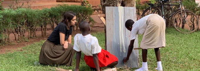 Kennedy George with students in Uganda.