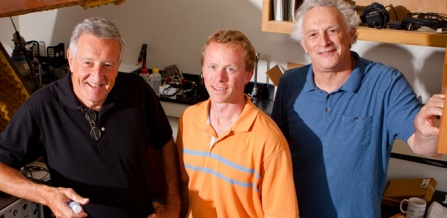 three male scientists in casual clothing in a laboratory.