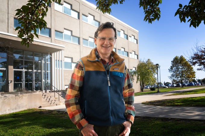 Michael J. Oldani, PhD, standing in front of a building on South Campus. 