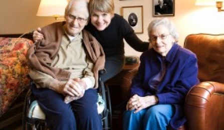 Photo of young woman with older adult couple.