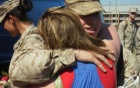Soldier embraces partner.