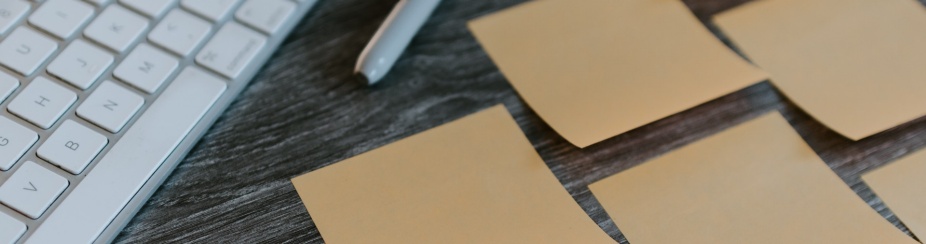 Post-it notes organized on a desk.