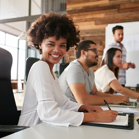 Royalty-free stock photo college student using laptop and talking, learning exchanging ideas.