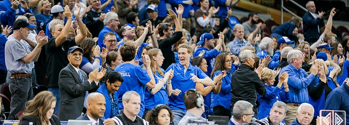 President Tripathi and other Bulls fans cheer in the stands at the 2016 MAC Championship games.