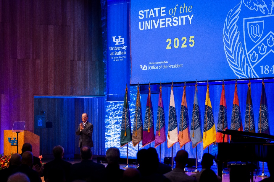 President Satish K. Tripathi stands on stage after his State of the University address.