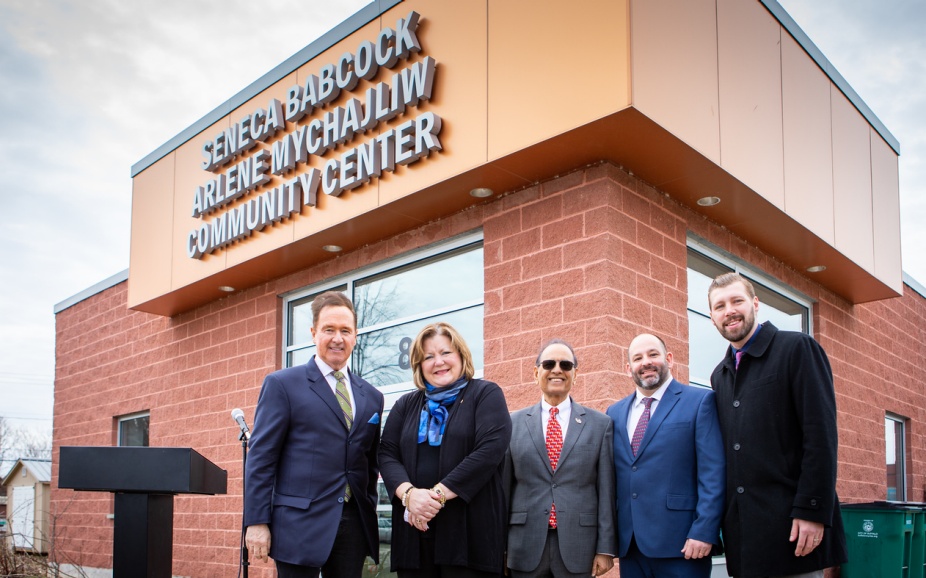 Rep. Brian Higgins, Dean Jean Wactawski-Wende, President Satish K. Tripathi, Brian Pilarski, executive director of Seneca Babcock Community Association, and Bryan Bollman, Buffalo Common Council member, pose in front of the Seneca Babcock Arlene Mychajliw Community Center.