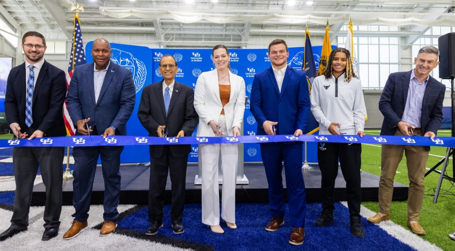 A group poses for a ribbon cutting.