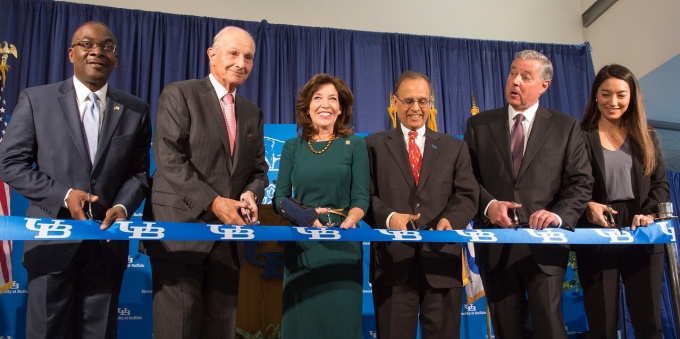 Speakers at the grand opening ceremony for the new Jacobs School of Medicine and Biomedical Sciences building cut the ribbon.
