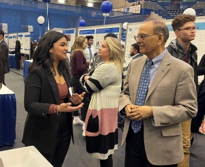 President Satish K. Tripathi speaks with a student about their research.