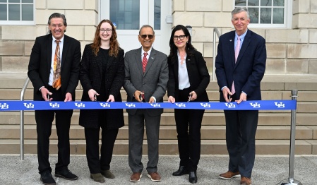 President Satish K. Tripathi and others participate in the ribbon cutting for Crosby Hall's Ceremonial Reopening. 
