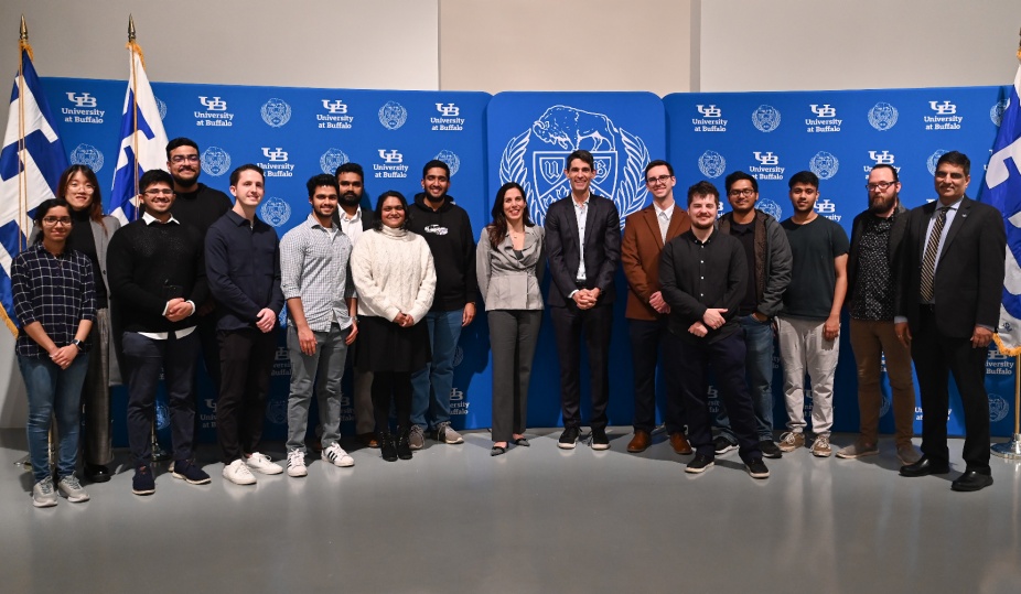 Technologist Nicholas Thompson and neuroethicist Nita Farahany pose with a group of UB students.